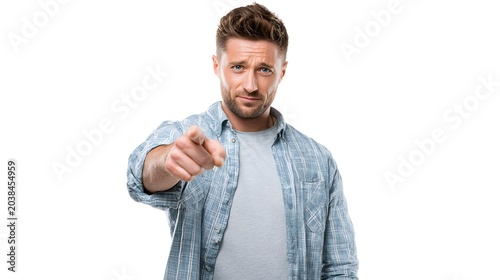 A person pointing straight ahead at the viewer with a serious expression. Isolated on white background.