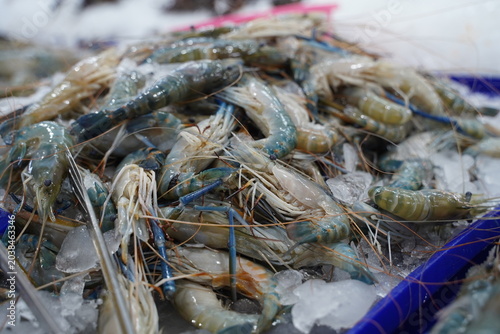 High angle view of raw and fresh Shrimp  displayed on ice tray in a traditional wet market in Thailand.