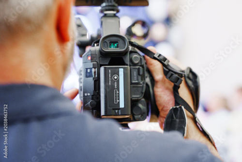 Cameraman Holding Professional Video Rig from Behind