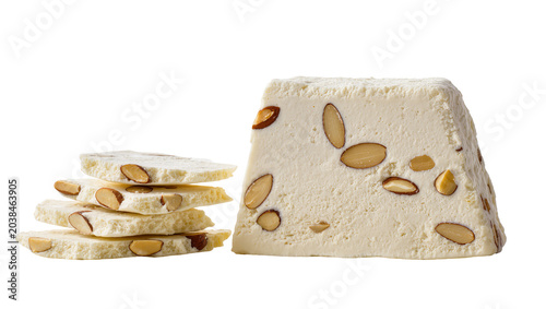 Φωτογραφία White nougat confection with almonds stacked and sliced