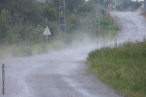 Rainwater Evaporating and Steaming on a Wet Rural Asphalt Road After Summer Storm