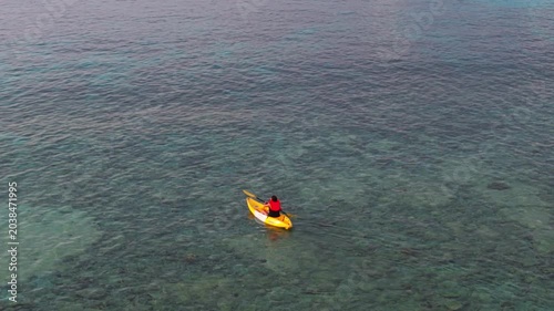 Aerial view of woman traveller exploring calm tropical bay ,Travel and Active Lifestyle concept	