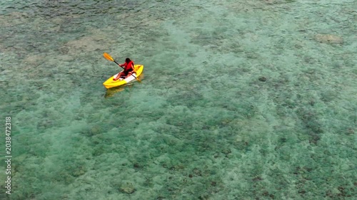 Aerial view of woman traveller exploring calm tropical bay ,Travel and Active Lifestyle concept