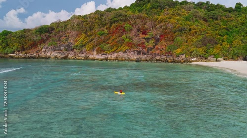 Aerial view of woman traveller exploring calm tropical bay ,Travel and Active Lifestyle concept	