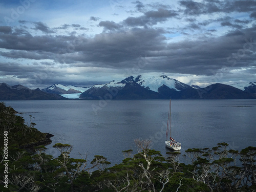 This image depicts a sailing expedition through the remote fjords of Patagonia, a region spanning southern Argentina 