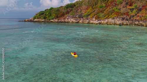 Aerial view of woman traveller exploring calm tropical bay ,Travel and Active Lifestyle concept	
