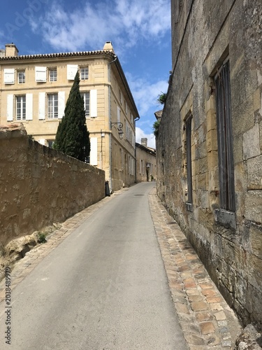Narrow Cobblestone Street Between Historic Stone Buildings in Saint Emilion France