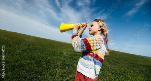 Photos Girl imagining adventures with pretend telescope outdoors
