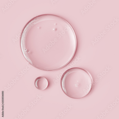 Serum oil sample round shape drops on pink background, 3d rendering gel with hyaluronic acids