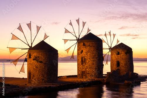 Traditional Greek windmills at Chios coast during morning twilight. Historic landmark in Greece.