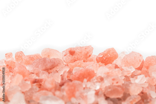 Close-up of pink himalayan salt on white background with copy space for text.