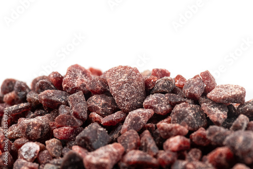 Close-up of black himalayan salt on white background.