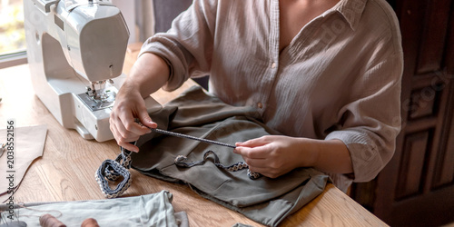 Obraz na plátne Upcycling clothing, woman repairing and altering garment at home, second life fa