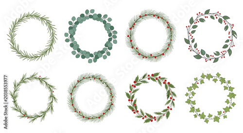 Collection of different botanical wreaths made from evergreen branches holly berries and eucalyptus leaves for festive decorations.