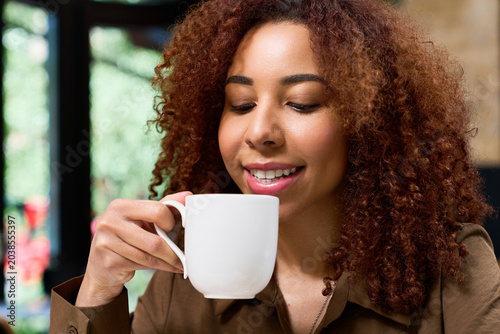 Slika na platnu Joyful moments with coffee in a vibrant cafe setting on a sunny afternoon