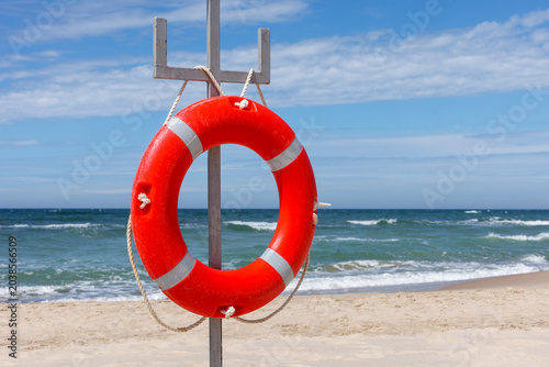 Foto Red lifebuoy on the background of the sea