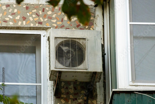 Photos air conditioner, condenser unit, compressor on facade of building