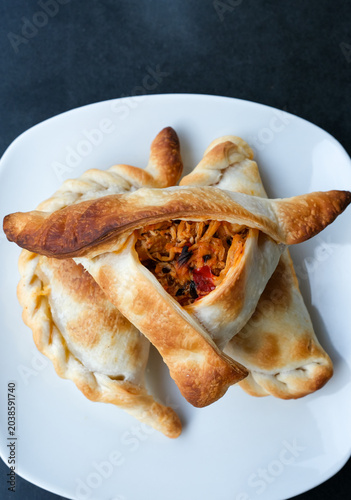 Rustic empanadas with Argentine culinary traditions. Catalonia travel. Snacks in tourist places. Shallow depth of field.