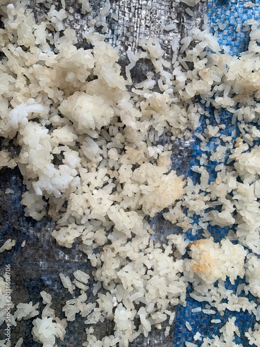 Leftover rice is dried in the sun on a bamboo tray, in Indonesia it is called nasi aking