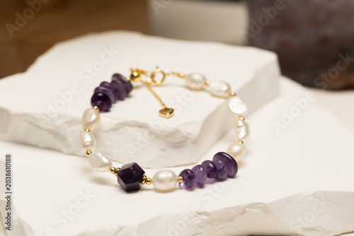 Handmade bracelet featuring amethyst beads, pearl beads, and gold spacer beads. Fashion jewelry accessory for jewelry making and DIY crafts.
