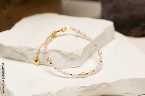 Handmade beaded bracelet featuring rose quartz beads, pearl beads, and gold spacer beads. Fashion jewelry accessory for jewelry making and DIY crafts.