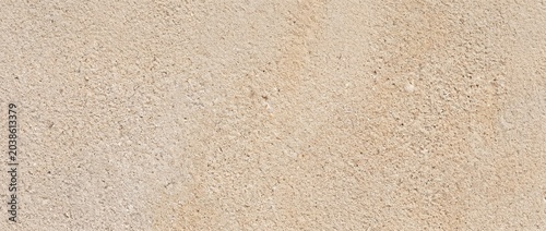 Bild auf Leinwand The background is fine-grained sandstone, a neutral warm sandy beige color with subtle tonal variations