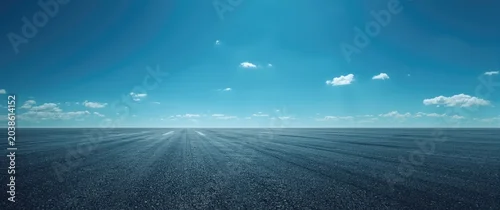 Panel kuchenny z motywem Expansive asphalt surface under a clear vibrant sky with few clouds