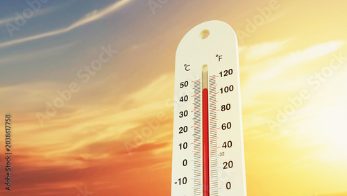 An outdoor thermometer showing dangerously high temperatures against a dramatic orange and yellow sunset sky, conceptualizing global warming, an extreme summer heatwave, and climate change crisis.