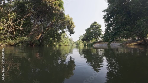River Rafting on Calm Tropical River Surrounded by Lush Green Forest