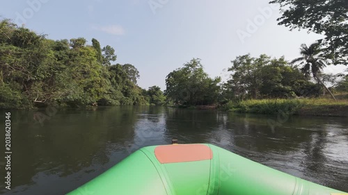 River Rafting on Calm Tropical River Surrounded by Lush Green Forest