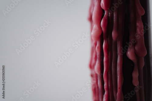 Closeup of melted red wax texture on light background