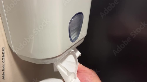 Pulling Paper Towel from Public Restroom Dispenser