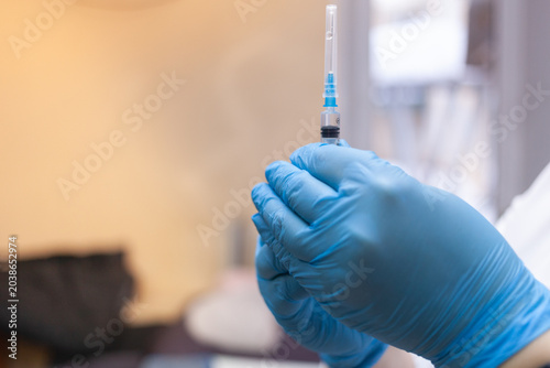 Tableau sur toile Nurse draws covid-19 vaccine into syringe before injection