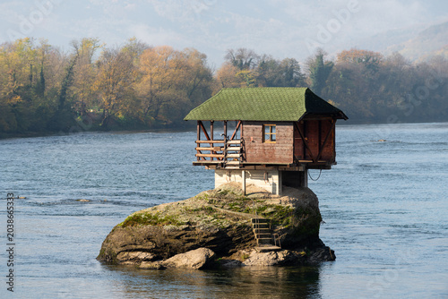Small wooden house on rock in middle of Drina river near Bajina Basta in Serbia during sunny day