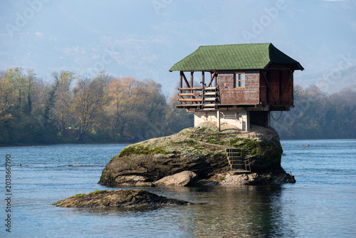 Small wooden house on rock in middle of Drina river near Bajina Basta in Serbia during sunny day