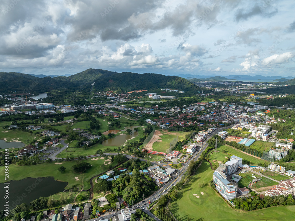 Fototapeta premium Aerial view drone shot of beautiful golf field in Phuket island Thailand