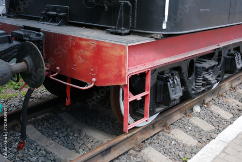 Tableau sur toile Vintage train wheels on railway tracks in a quaint station setting