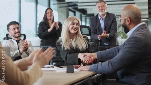 Professional team discusses strategy around polished conference table