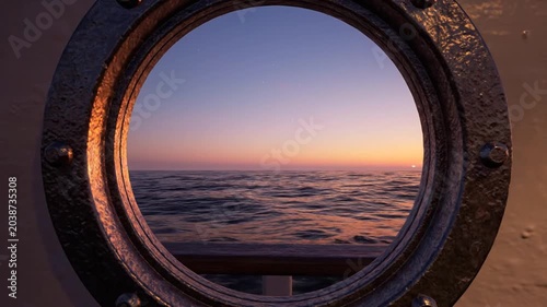 Sunset view through a ship porthole on the ocean