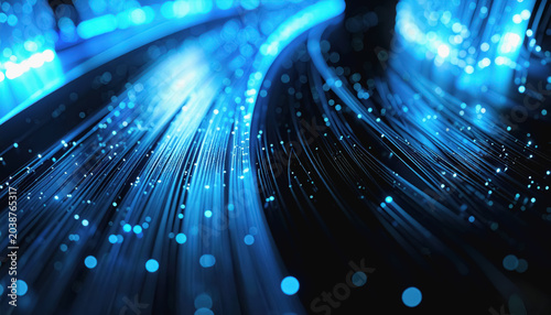 Close-up of Blue Fiber Optic Strands with Glowing Particles and Bokeh