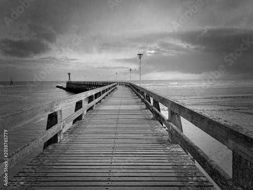 Tableau sur toile a wooden pier overlooking the sea in French Normandie