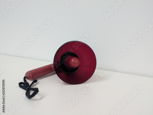 Portable Red Bullhorn Loudspeaker Isolated on White / 白背景の赤いポータブル拡声器・メガホン