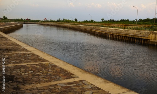an artificial reservoir or dam with calm water
