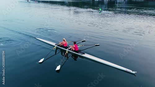 Exciting display of young women training vigorously in a two-seater rowing boat on the stunning waters of Halifax Ocean Bay, Canada. Their dedication shines through as they navigate the waves
