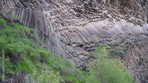 Rocky cliffs at Symphony of Stones in Armenia with trees moving in wind
