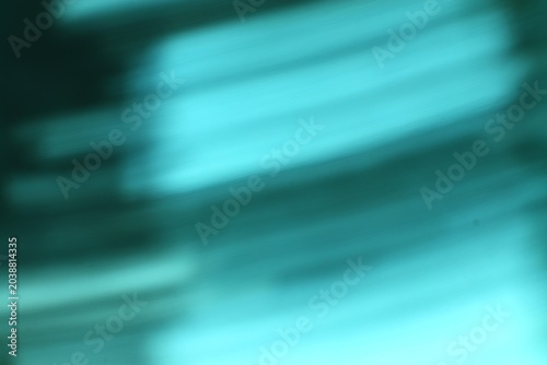 Blurry abstract image with dynamic teal and dark streaks