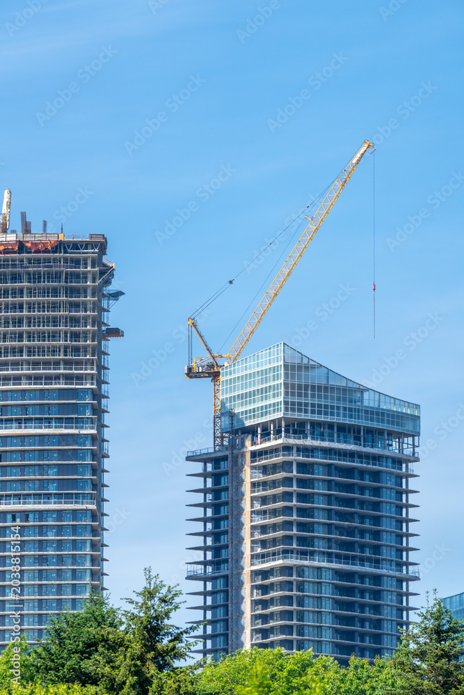 Fototapeta premium High Rise Construction With Tower Cranes