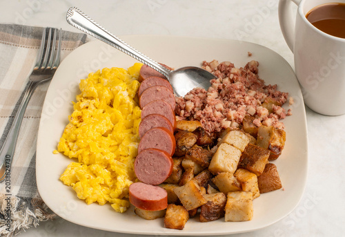 scramble eggs  with kielbasa , home fries and corn beef hash