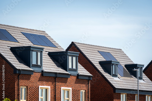 Photovoltaic solar panels on the roof of new built house in england uk. The concept of a sustainable environment, construction.