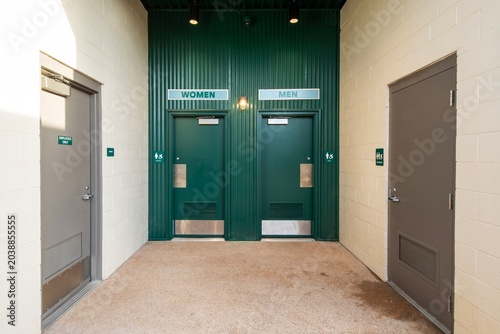Exterior entrance to public male and female restrooms with green doors